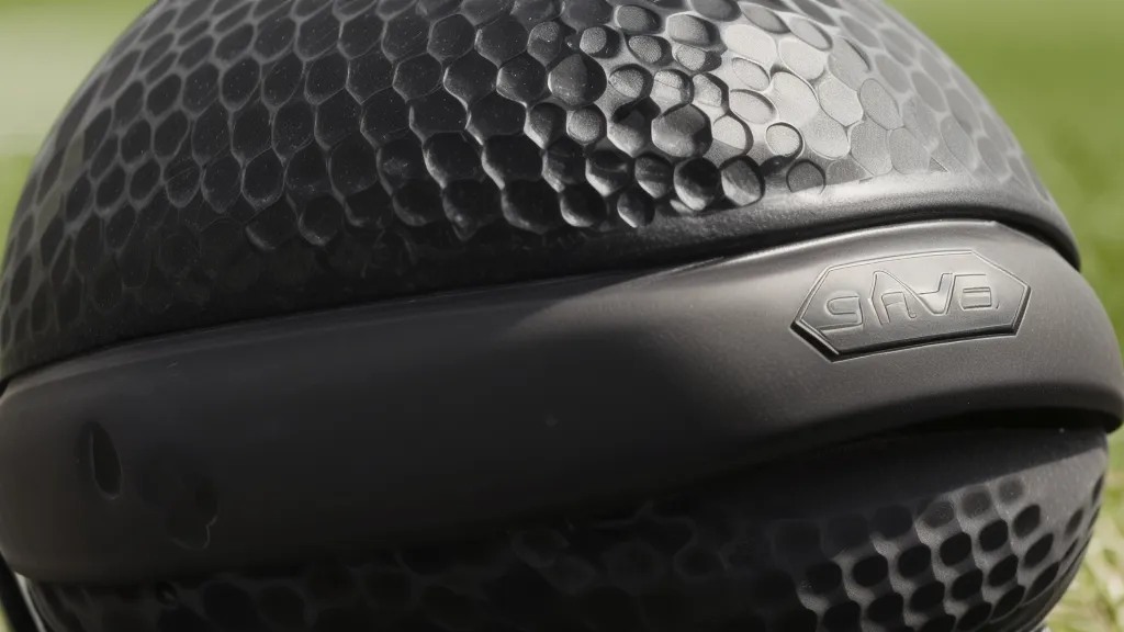 Close-up of the matte black crown of a Cobra DarkSpeed driver in bright sunlight.